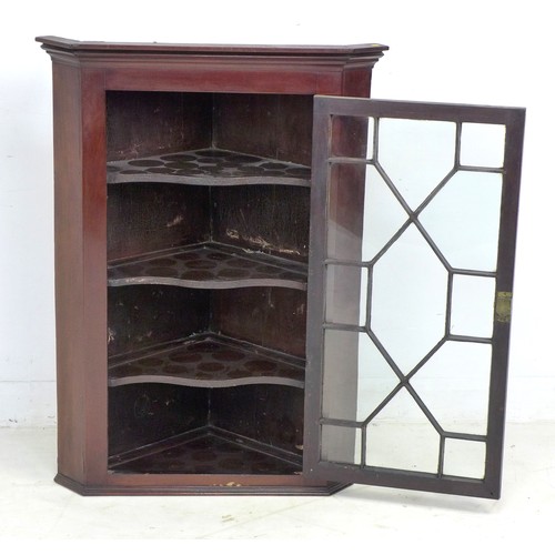 330 - A George III mahogany corner cupboard, single astragal glazed door, three shaped shelves, with key, ... 