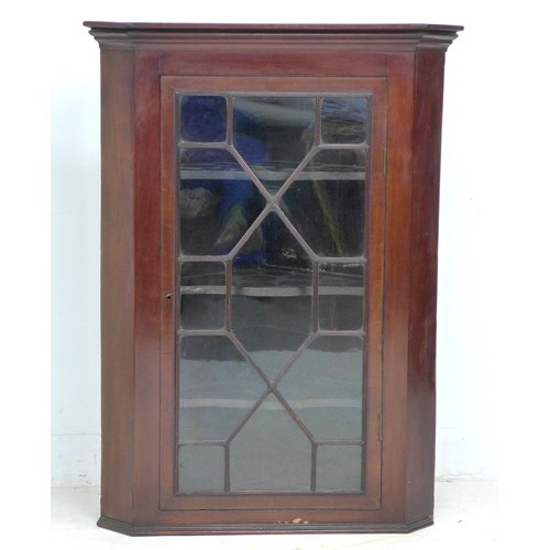 330 - A George III mahogany corner cupboard, single astragal glazed door, three shaped shelves, with key, ... 