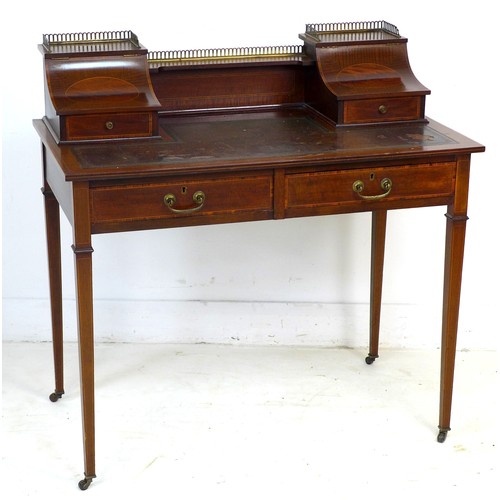 349 - An Edwardian mahogany and line inlaid lady's writing desk, brass gallery and shelf between two conca... 