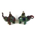 A pair of Chinese Tang style figures, modelled as elephants each with a figure riding on it's back, ... 