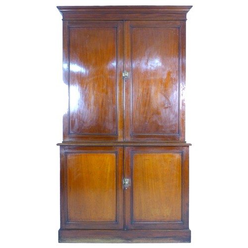 352 - A Victorian mahogany Estate cupboard, the upper section with twin doors opening to reveal an arrange... 