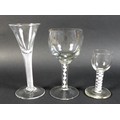 A group of three Georgian drinking glasses, comprising a wine glass the ovoid bowl above milk glass ... 