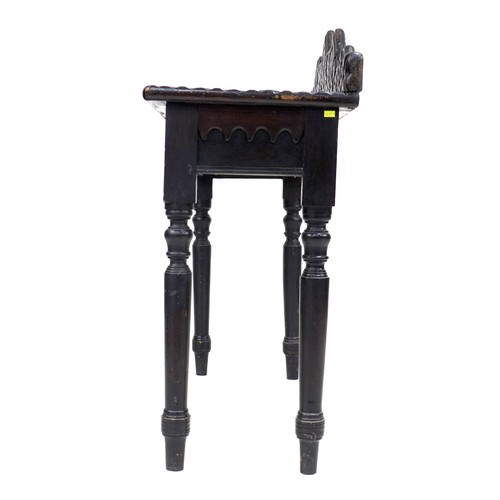 354 - An unusual 19th century ebonised oak side table, the surface and upstand applied with moulding cut i... 