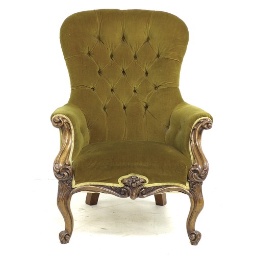 333 - A Victorian mahogany spoon back armchair, upholstered in buttoned mustard velvet, foliate carved fro... 