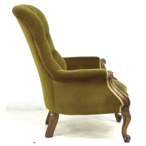 333 - A Victorian mahogany spoon back armchair, upholstered in buttoned mustard velvet, foliate carved fro... 