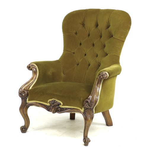 333 - A Victorian mahogany spoon back armchair, upholstered in buttoned mustard velvet, foliate carved fro... 