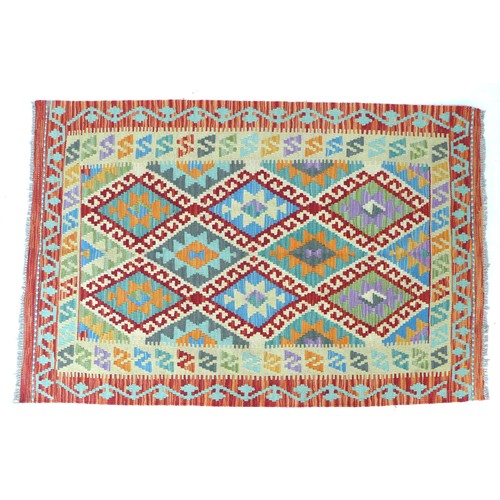 340 - A vegetable dyed wool Choli Kelim rug, with cream ground and orange borders, eight lozenges with geo... 