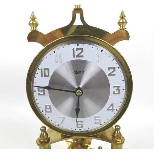 148 - A Kundo torsion clock, on a brass effect circular base, with glass dome, dial 9cm, 19 by 30cm high o... 