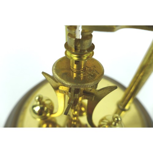 148 - A Kundo torsion clock, on a brass effect circular base, with glass dome, dial 9cm, 19 by 30cm high o... 