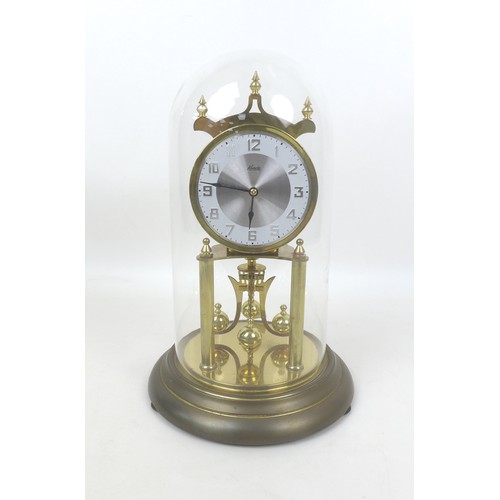 148 - A Kundo torsion clock, on a brass effect circular base, with glass dome, dial 9cm, 19 by 30cm high o... 