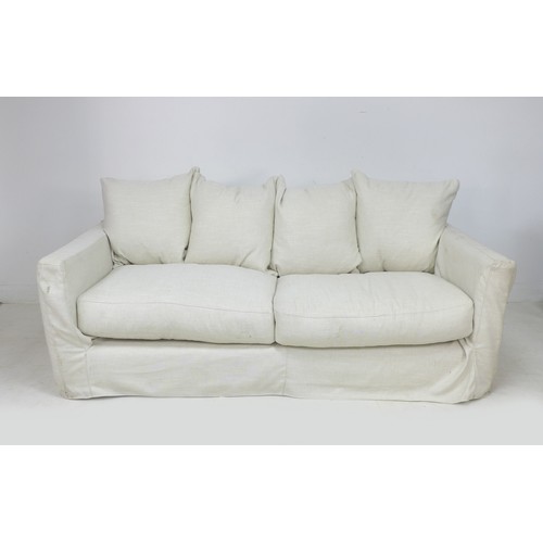 273 - A modern three seater sofa, upholstered in white cotton, 208 by 101 by 90cm high.