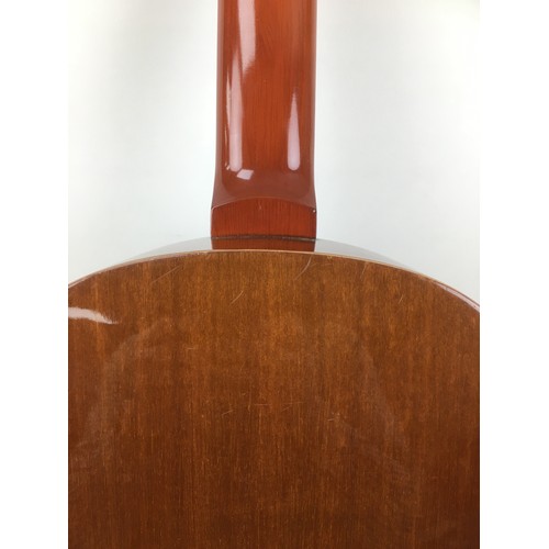 125 - A Spanish made classical guitar by Almeria, label to interior.