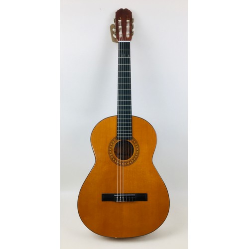 125 - A Spanish made classical guitar by Almeria, label to interior.