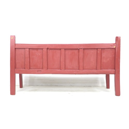 338 - A Chinese style red painted pine bench, late 19th / early 20th century, with low six panel back, sha... 