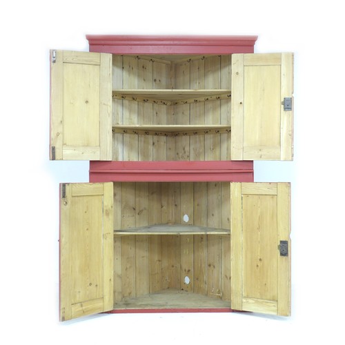 257 - A Victorian red painted freestanding pine corner cupboard, double doors enclosing shelves to both an... 