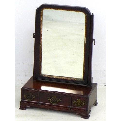 312 - An early Georgian mahogany toilet mirror, the rectangular plate with moulded frame and gilt slip, th... 