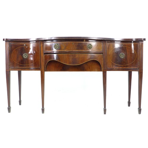 333 - A George III mahogany sideboard, serpentine fronted, crossbanded and inlaid, two cupboards flanking ... 