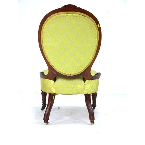 291 - A Victorian mahogany spoon back nursing chair, with floral carved and moulded frame, upholstered in ... 