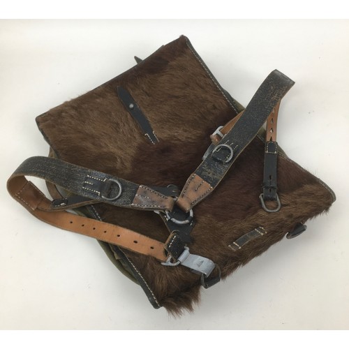 130 - A WWII German Army Tornister backpack with webbing and pony hide to the front, together with a leath... 