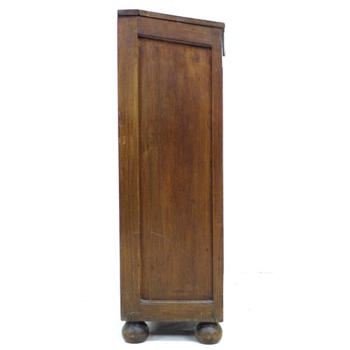 213 - An oak freestanding cupboard, of tall narrow form with sloped lift lid, raised on turned feet, 51 by... 