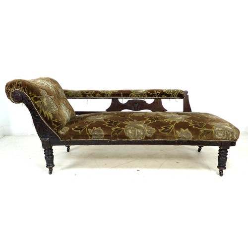 300 - A late Victorian mahogany chaise longue, with carved frame, turned legs and castors, upholstered in ... 