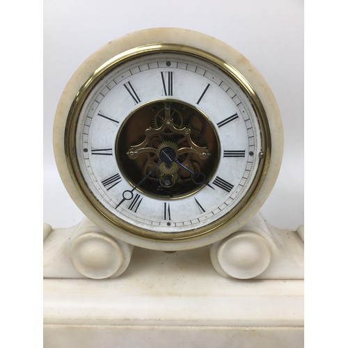 149 - A group of three mantel clocks, comprising a Victorian slate clock, 25 by 35cm, a Victorian white al... 