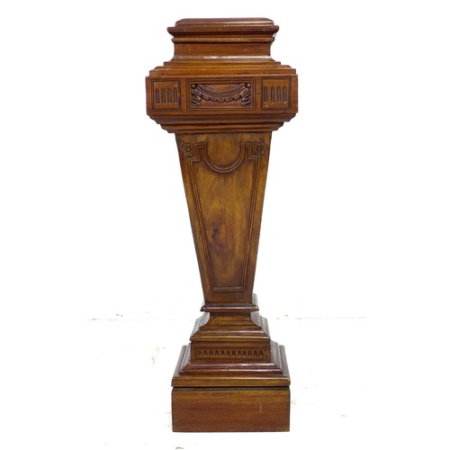 241 - A reproduction Victorian style mahogany pedestal, with carved decoration, and of stepped and taperin... 