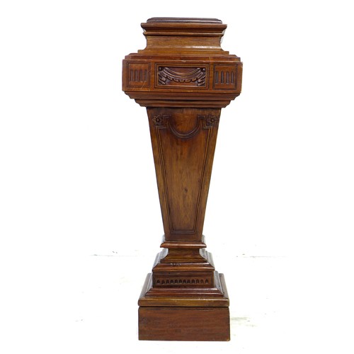 241 - A reproduction Victorian style mahogany pedestal, with carved decoration, and of stepped and taperin... 