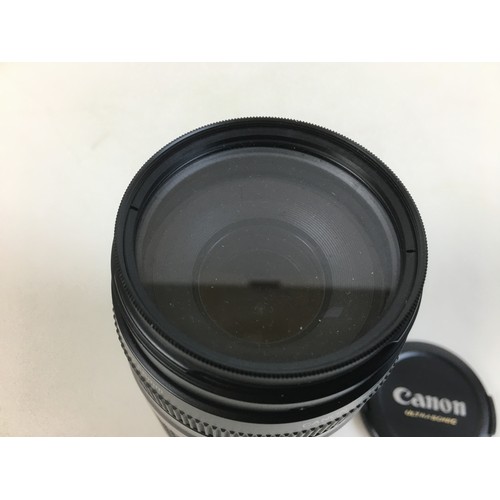 84 - A Canon Ultrasonic Zoom lens EF 75-300mm lens and two Canon cameras, an Ultrasonic EOS 1000F N and a... 