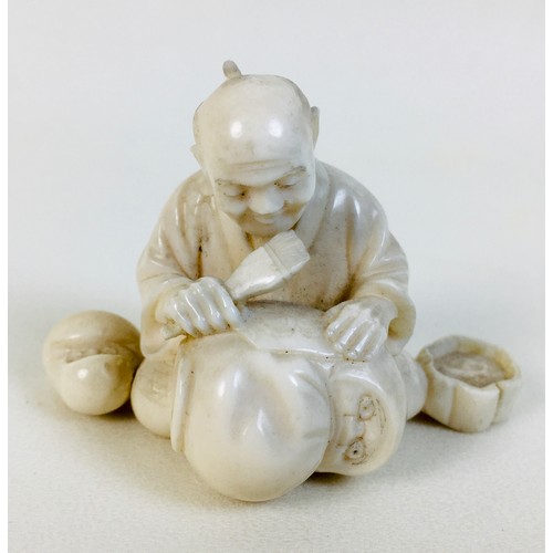 4 - A late 19th century Japanese ivory okimono of a craftsman painting Daruma dolls, signed 'Mitsumasa' ... 