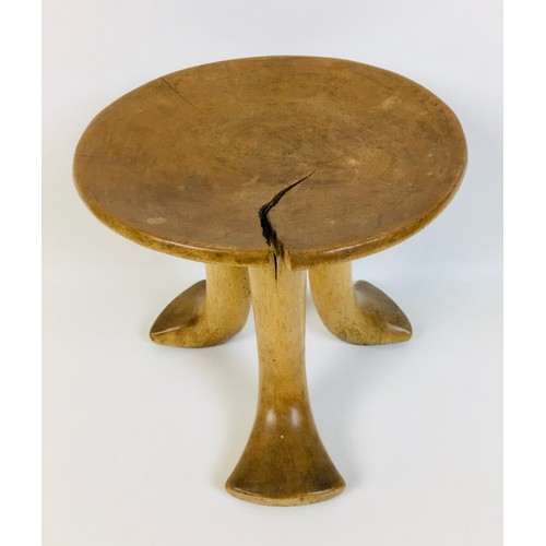 99 - A group of five tribal carved wooden items, comprising a small Ethiopian tripod stool, with circular... 