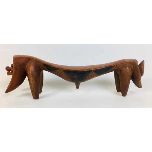 99 - A group of five tribal carved wooden items, comprising a small Ethiopian tripod stool, with circular... 