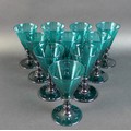 A set of ten Regency Bristol green wine glasses, with conical bowls and knopped stems, rough pontil ... 