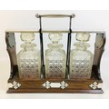 An Edwardian Atkin Bros oak tantalus, with EPNS mounts, a Hobbs & Co. lock, currently unlocked and w... 