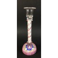 A glass candlestick with candy twist stem in white red and clear glass and millefiore paperweight ba... 
