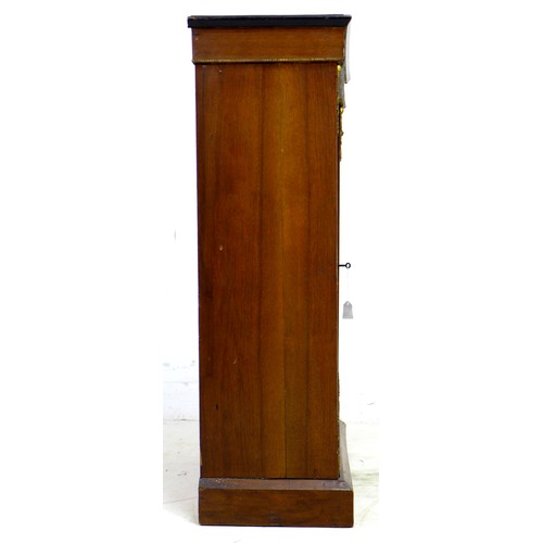 256 - A 19th century walnut pier cabinet, possibly French, the single glazed doors enclosing two shelves, ... 