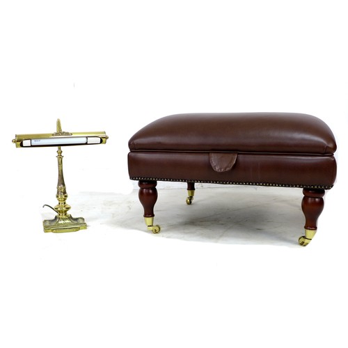 232 - A modern leather covered Ottoman, of square form covered in brown leather and raised on turned balus... 