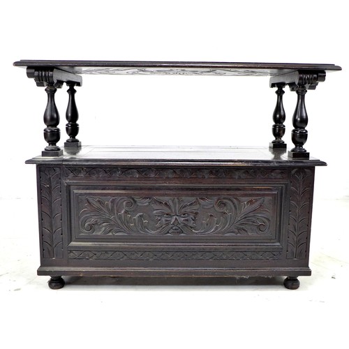 306 - A stained and carved oak monk's bench, mid 20th century, with lifting and sliding top, a/f detached ... 