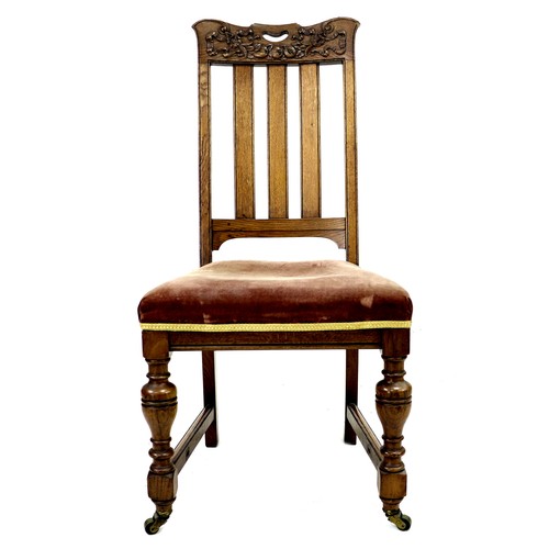 307 - A set of four late Victorian oak dining chairs, the rails carved with fruit and ribbons, slat backs,... 