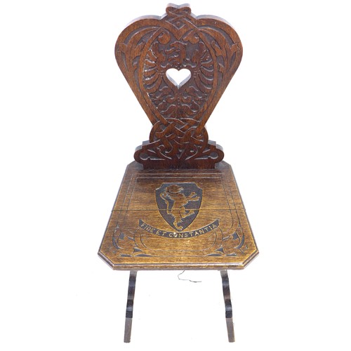 292 - A mid 20th century stained oak hall chair, the seat and back carved with a lion crest and motto 'Fid... 