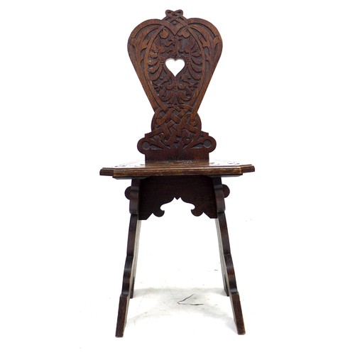 292 - A mid 20th century stained oak hall chair, the seat and back carved with a lion crest and motto 'Fid... 