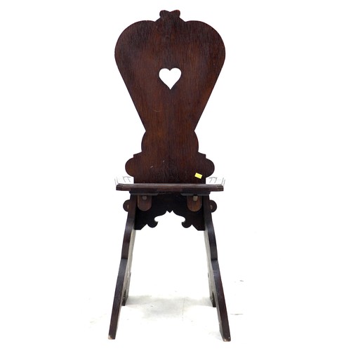 292 - A mid 20th century stained oak hall chair, the seat and back carved with a lion crest and motto 'Fid... 