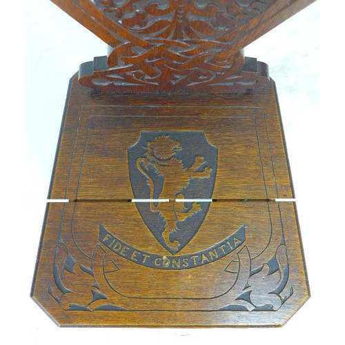 292 - A mid 20th century stained oak hall chair, the seat and back carved with a lion crest and motto 'Fid... 