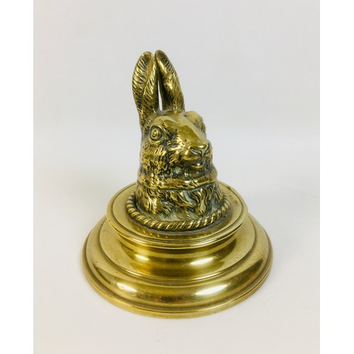 93 - An early 20th century brass rabbit headed inkwell stand with circular base, without glass liner, 12 ... 