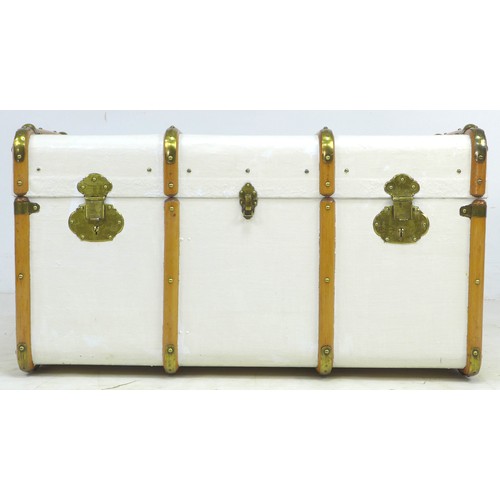 203 - An early 20th century travelling trunk, white painted canvas and wooden bound, leather carrying hand... 