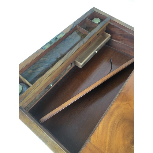 108 - A 19th century walnut writing slope, with fittings and key, its interior with original glass brass t... 