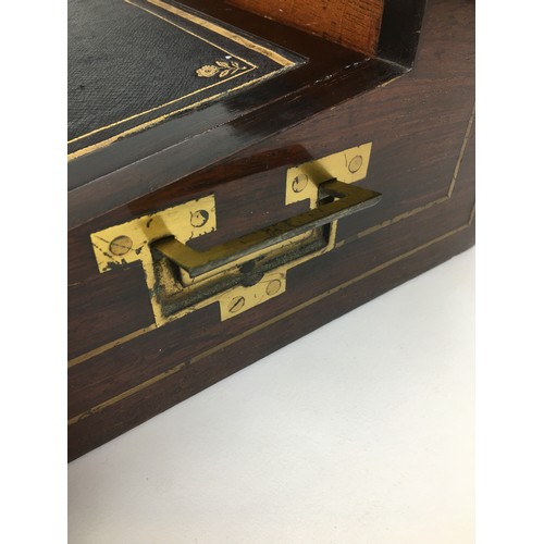 109 - A 19th century mahogany writing slope, with brass fittings including side campaign style handles and... 