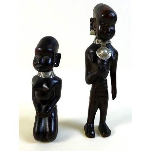 100 - A group of likely mid 20th century African sculptures, comprising a pair of figures possibly depicti... 