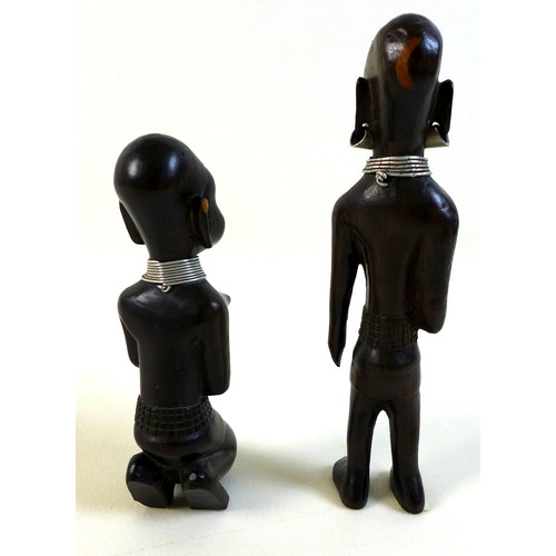 100 - A group of likely mid 20th century African sculptures, comprising a pair of figures possibly depicti... 