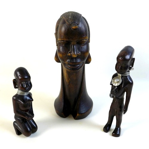 100 - A group of likely mid 20th century African sculptures, comprising a pair of figures possibly depicti... 